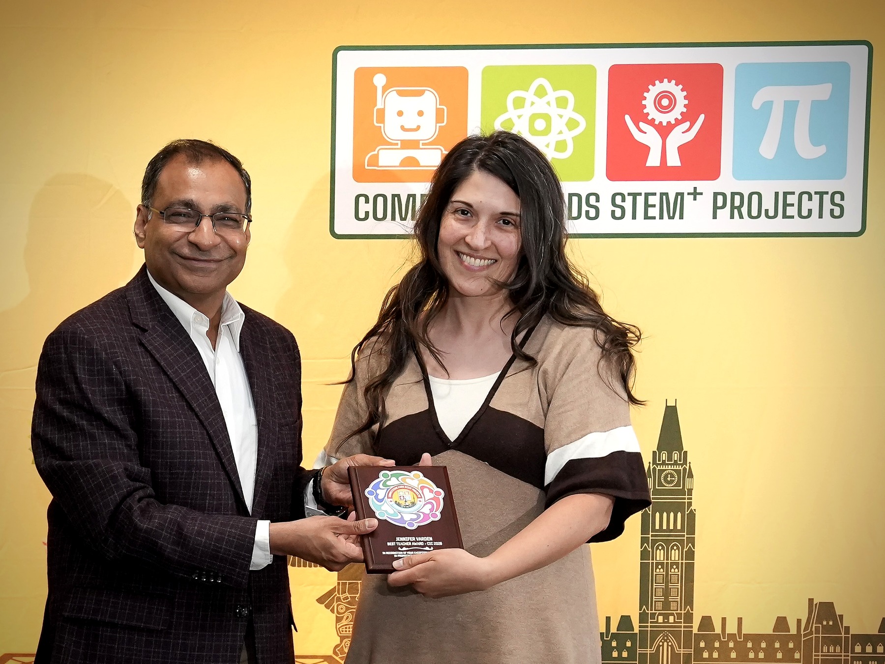 Mr. Amit Goyal presents the 2026 Best Teacher Award to Jennifer Varden.