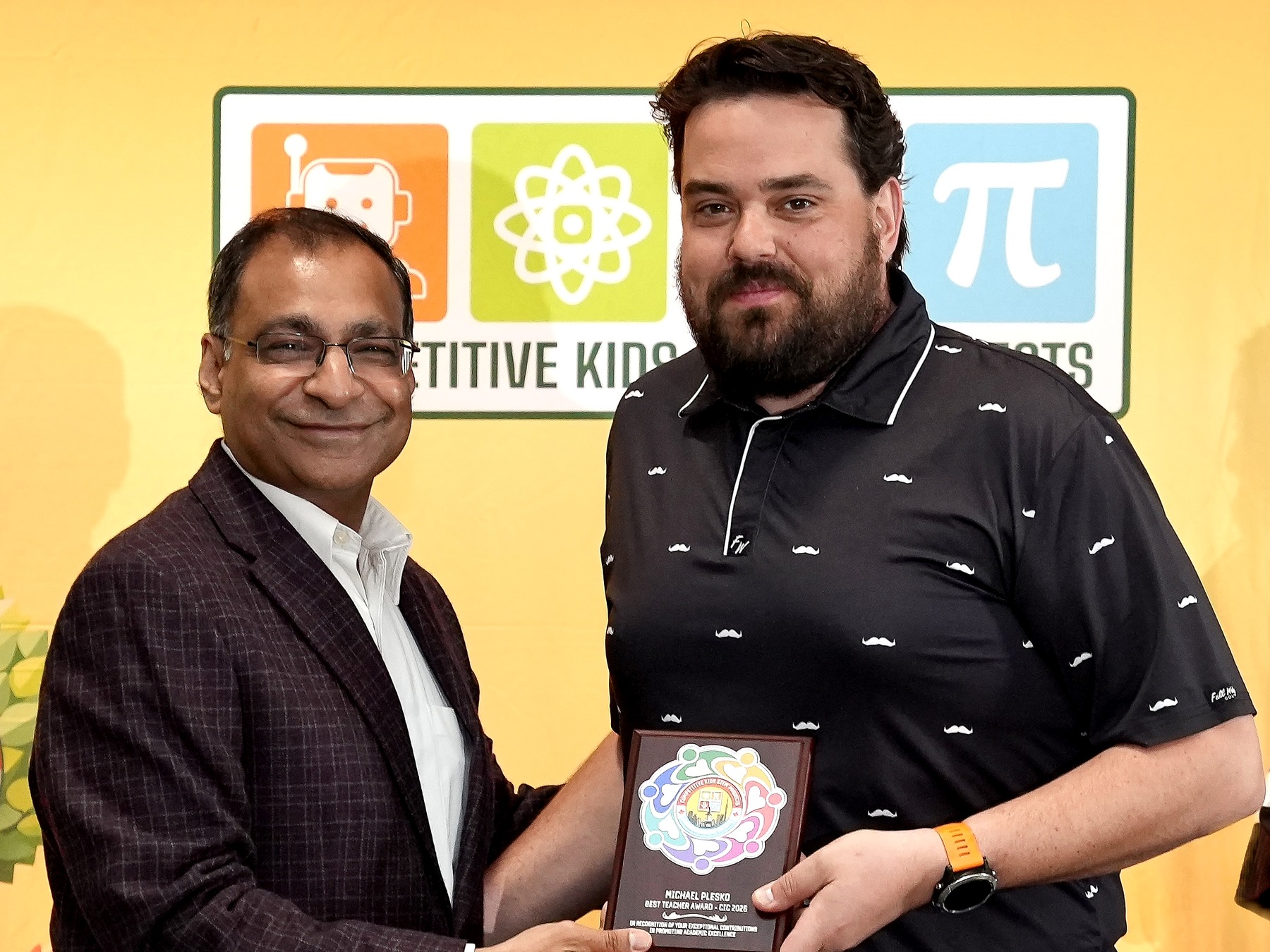 Mr. Amit Goyal presents the 2026 Best Teacher Award to Michael Plesko.