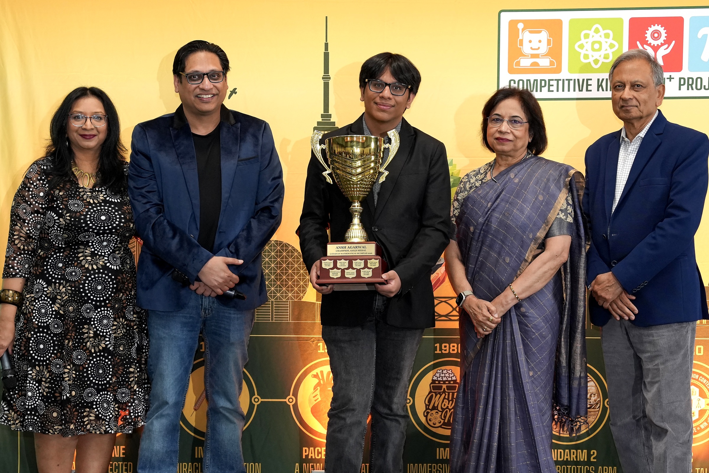 Ansh Agarwal with the gold championship trophy and the CKSTEM team.